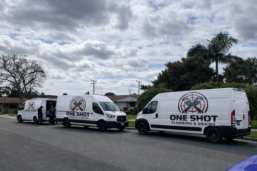 One Shot team and branded service trucks